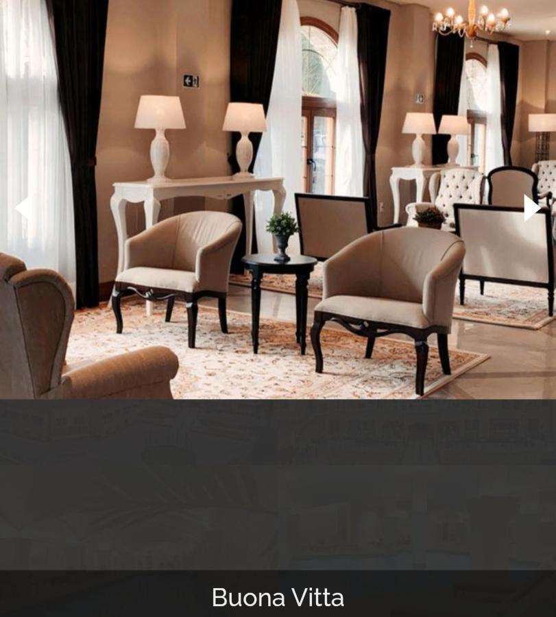 Buona Vitta Gramado Resort & Spa By Gramado Parks Zewnętrze zdjęcie The photo shows a stylish and inviting interior space, likely a lounge or waiting area. There are beige upholstered armchairs arranged around a small black table. A decorative plant is placed on the table. Behind the chairs are light-colored walls wi